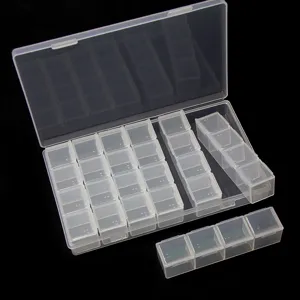 Transparent plastic storage box detail view with multiple compartments for jewelry and beads.