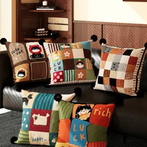 Close-up detail of vintage style retro cat pattern throw pillow cushion with decorative pom poms.