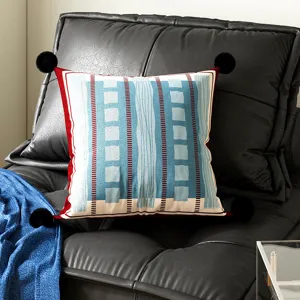 Bauhaus style geometric square throw pillow with black pom-poms, decorative cushion for sofa.