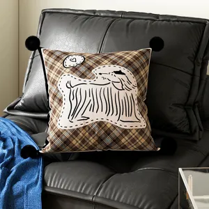 Brown plaid cushion with four black pom-poms and cute shaggy dog illustration for sofa.