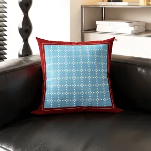 Detail shot of a mid-century Bauhaus style throw pillow cover on a modern leather sofa.