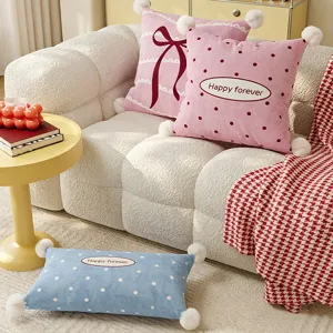 Cozy plush throw pillow with cute pom-pom trim and bow design, soft sofa cushion for home decor.