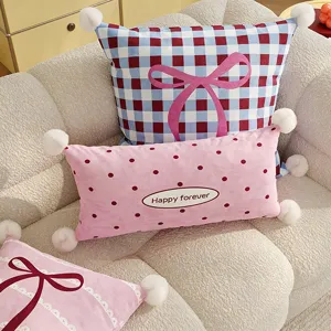 Cute decorative throw pillows set with bow and pom poms for living room sofa and bed decor.