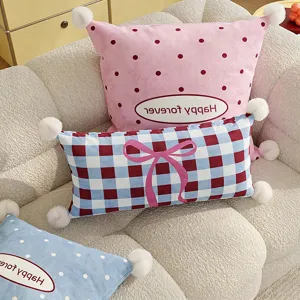 Decorative throw pillow set with cute bow and polka dot design for living room sofa.
