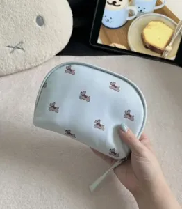Portable travel cosmetic pouch cute dog print makeup organizer bag for daily storage.