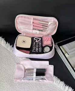 Detailed view of the pink polka dot cosmetic bag showcasing interior brush slots and spacious compartments.