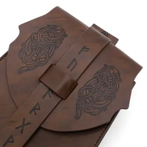 Close-up detail of medieval vintage embossed leather Viking pouch with intricate rune design.