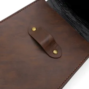 Close-up detail of medieval vintage brown faux leather pouch with metal rivets and strap.