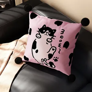 Pink cartoon cat throw pillow with cute black pom poms for living room sofa decor.