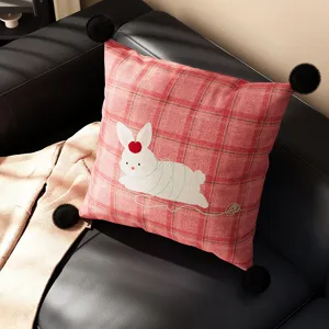 Red plaid throw pillow with cute white bunny and black pom poms for living room sofa decor