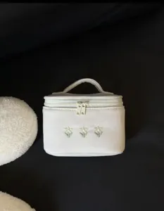Large capacity portable cosmetic bag with cute floral embroidery and double zippers for travel.