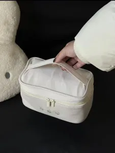 Large capacity cosmetic bag with handle, portable makeup storage pouch for women travel use.