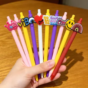 Close-up of colorful retractable ballpoint pens with cute 3D cartoon toppers for student stationery.