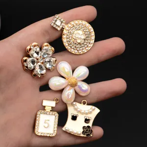 Detail view of luxury designer style DIY shoe charms featuring rhinestone flowers and pearls.