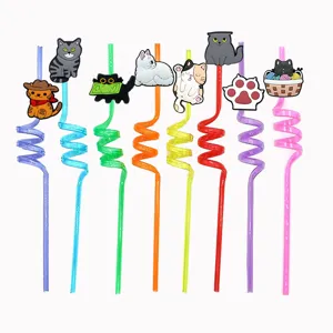Close-up detail of colorful spiral drinking straws featuring cute silicone cartoon cat toppers and charms.