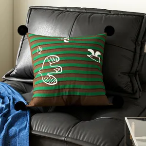 Bauhaus style throw pillow with green brown stripes and white birds. Cozy sofa cushion cover.