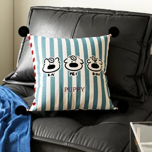 Blue and white striped throw pillow with cute cartoon designs and pom poms for living room sofa.