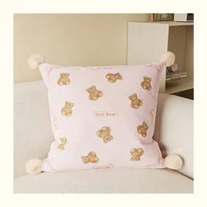 Cream style pink teddy bear throw pillow with cute print, pom-poms, and soft cushion insert.
