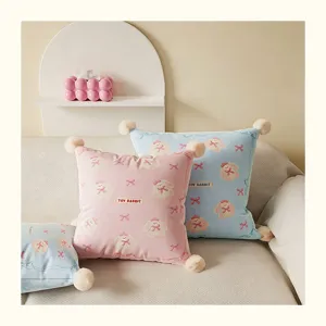 Cream style cute cartoon rabbit plush throw pillow with pompoms, soft sofa cushion for home.