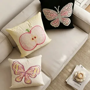 Korean style embroidered throw pillow detail showcasing exquisite butterfly and apple patterns.