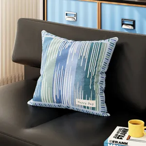 Blue and green striped throw pillow detail view, cozy home decor for sofa and living room.