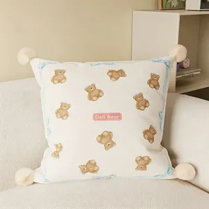 Cream style cute bear throw pillow with four pom poms and blue bow border for sofa living room