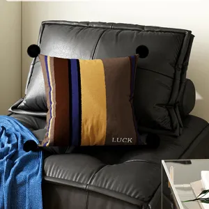Striped decorative throw pillow with black pom-poms, soft cushion for living room sofa.