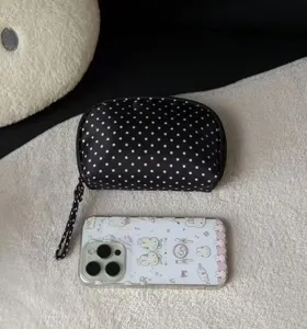 Classic black and white polka dot cosmetic bag with wrist strap, portable travel storage pouch