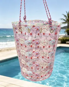 Transparent PVC waterproof beach bucket bag with cute cake print, large cosmetic travel storage.