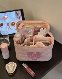 Pink quilted makeup bag with large capacity, cute heart embroidery, and multi storage design.