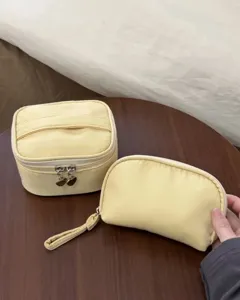 Yellow cosmetic bag set with spacious capacity and portable travel design for daily use.