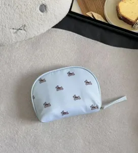Cute portable cosmetic storage bag with adorable puppy pattern, ideal for travel and organizing.