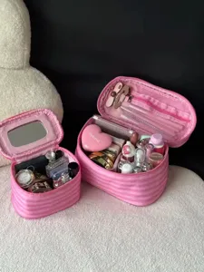 Pink striped makeup bag with mirror and compartments, portable cosmetic pouch for travel detail.