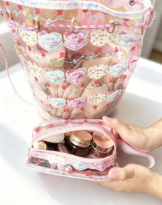 Clear PVC bucket bag and cosmetic pouch set with cute heart prints, waterproof travel storage.