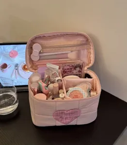 Pink quilted makeup bag with heart patch, large capacity portable travel cosmetic storage pouch.