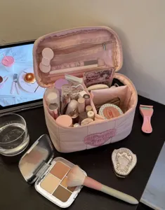 Large capacity pink travel cosmetic bag with heart embroidery and multiple compartments.