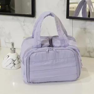 Close-up of the light purple quilted cosmetic bag showing multi-compartment travel storage.