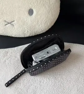Classic black polka dot cosmetic bag, large capacity portable travel toiletry pouch for women.