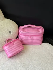 Pink striped cosmetic bag detail, portable makeup organizer pouch set for travel.