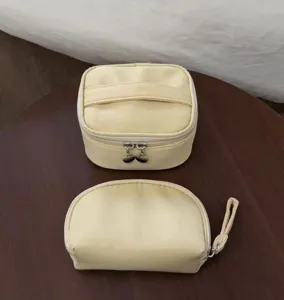Yellow cosmetic bag set detail view showing large capacity and portable storage design.