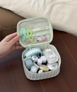 Portable striped cosmetic bag with large capacity, ideal for travel and daily storage.