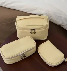 Yellow cosmetic bag set with large capacity and portable design for travel and daily storage.