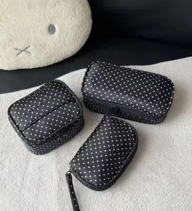Black and white polka dot cosmetic bag, large capacity portable travel makeup storage pouch with handle.