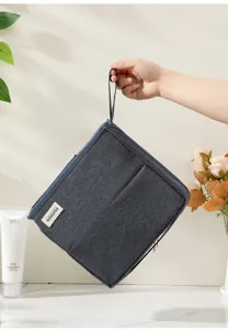 Large capacity fabric cosmetic bag travel storage pouch with handle and front pocket detail.