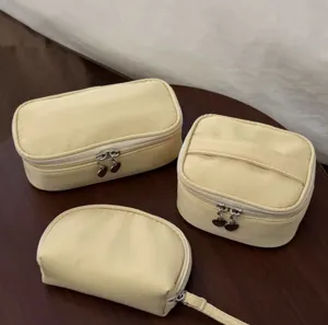 Yellow cosmetic bag set detail view, portable travel makeup organizer storage bags.