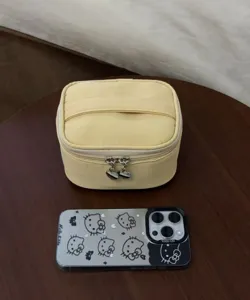 Yellow cosmetic bag detail showing portable makeup storage pouch and zipper design.