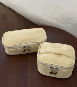 Yellow cosmetic bag set featuring cute heart zippers and portable travel makeup pouch details.