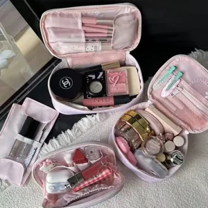 Pink multi-functional travel cosmetic bag with large capacity and multi-layer compartments.