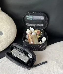 Classic black polka dot cosmetic bag with large capacity and portable design for travel and daily use.