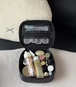 Classic black polka dot makeup bag with large capacity, portable design for travel storage.